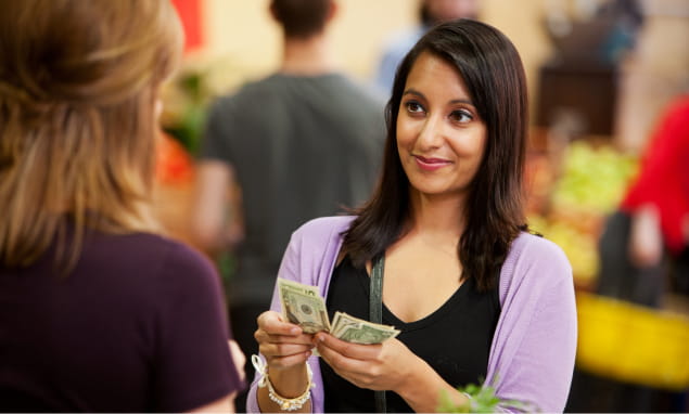 Woman paying at pharmacy counter